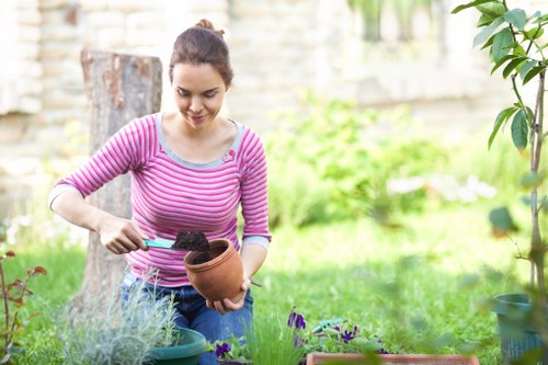 Lawn care and weed control as part of garden maintenance in Castelnau